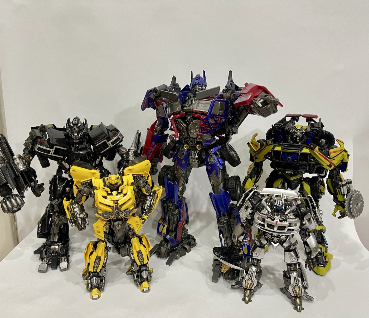 Five Transformers figures displayed together
