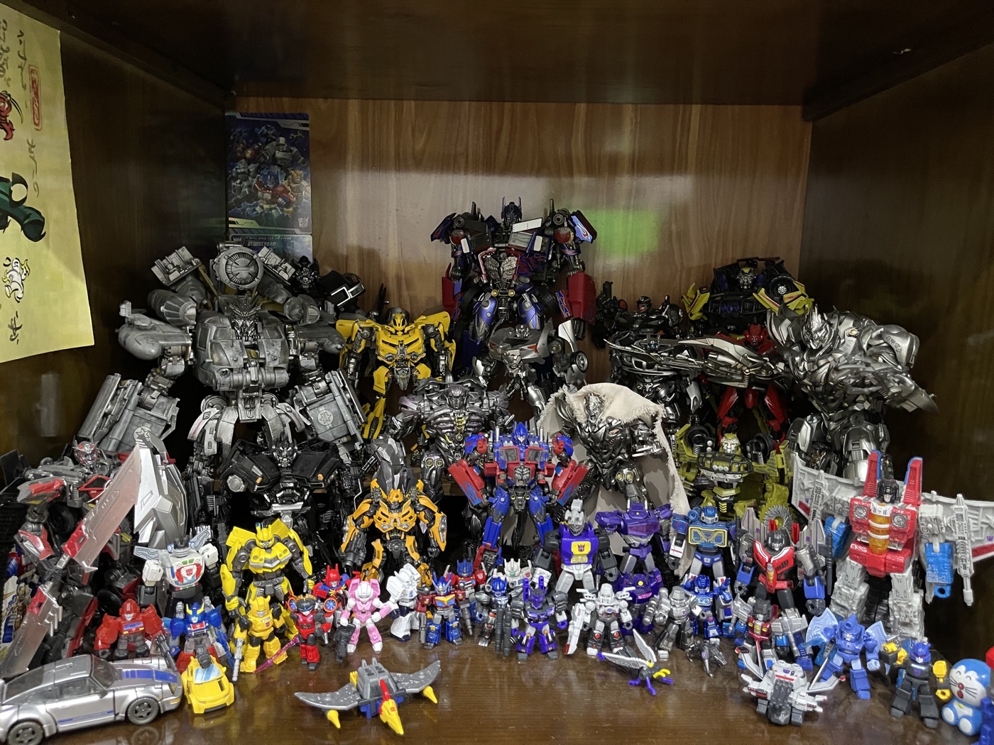 A shelf filled with Transformers figures